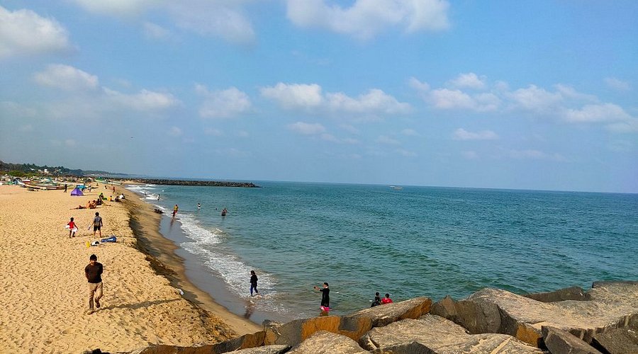 Serenity Beach in Pondicherry with sunrise, surfers, and golden sand