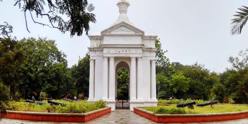 View of Bharathi Park in Puducherry with Aayi Mandapam monument surrounded by green trees and walking paths.