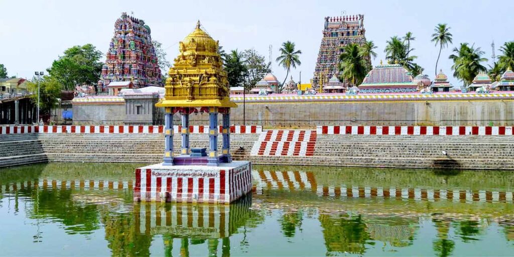 Sri Gokilambal Thirukameswarar Temple in Villianur, Pondicherry with tall gopuram and temple chariot pulled by devotees during Brahmotsavam.