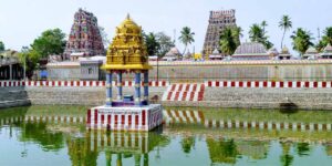 Sri Gokilambal Thirukameswarar Temple in Villianur, Pondicherry with tall gopuram and temple chariot pulled by devotees during Brahmotsavam.